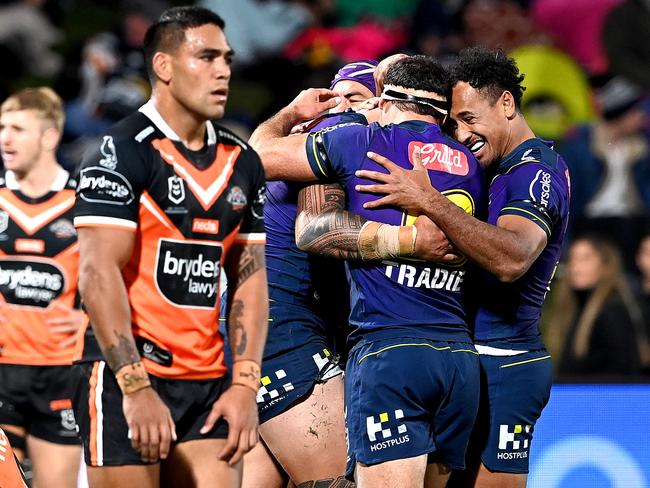 SUNSHINE COAST, AUSTRALIA - JUNE 19: Nelson Asofa-Solomona of the Storm is congratulated by team mates after scoring a try during the round 15 NRL match between the Melbourne Storm and the Wests Tigers at Sunshine Coast Stadium, on June 19, 2021, in Sunshine Coast, Australia. (Photo by Bradley Kanaris/Getty Images)