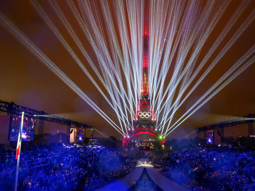 Overview of the Trocadero venue, with the Eiffel Tower looming in the background  and lasers lighting up the sky, during the opening ceremony of the Paris 2024 Olympic Games on July 26, 2024 (Photo by FranÃ§ois-Xavier MARIT / AFP)