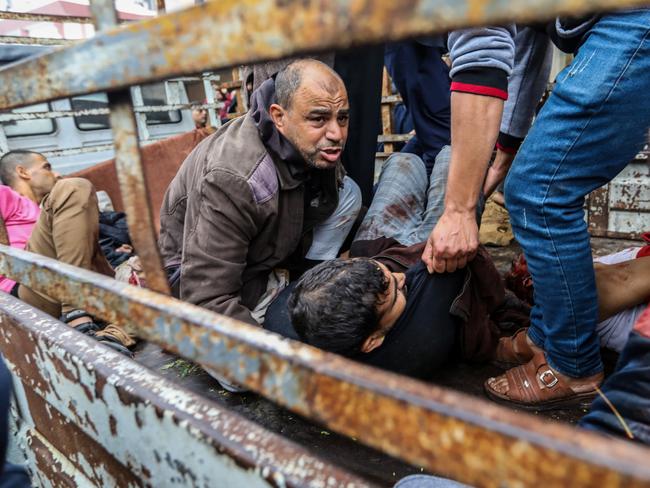 Palestinians injured in an Israeli air strike arrive on the back of a truck at Nasser Medical Hospital on December 5, 2023 in Khan Younis, Gaza. Picture: Getty Images