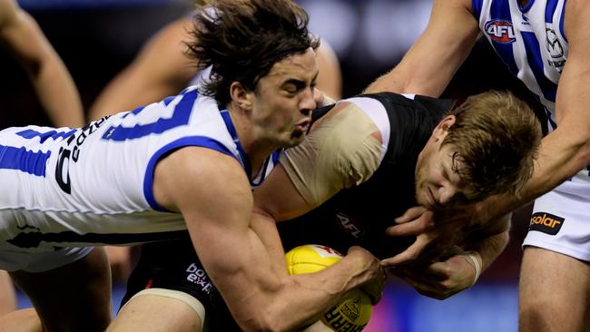 Taylor Garner of the Kangaroos (left) tackles Essendon’s Michael Hurley in 2017. Picture: AAP Image/Tracey Nearmy