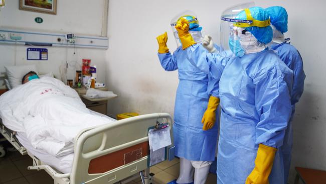 Medical staff members attend to a patient infected with coronavirus in an isolation ward at a hospital in Zouping, China. Picture: AFP