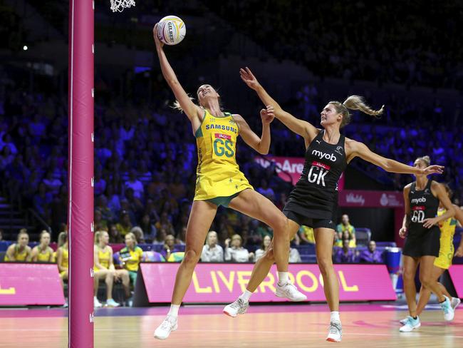 Australia's Caitlin Bassett, left, and New Zealand's Jane Watson battle for the ball during the Netball World Cup match in Liverpool, England, Thursday July 18, 2019. (Nigel French/PA via AP)