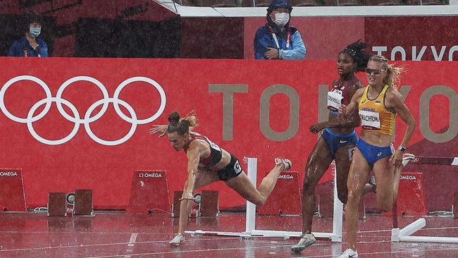 Denmark's Sara Slott Petersen (L) falls during the women's 400m hurdles semi-finals. Picture: Giuseppe Cacace/AFP