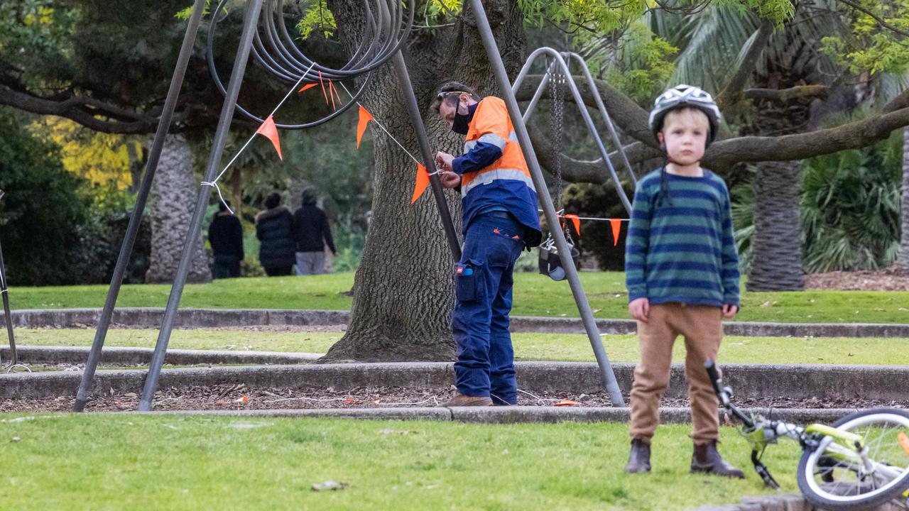 A worker fences off play equipment in St Kilda Botanical Gardens. Picture: Jason Edwards