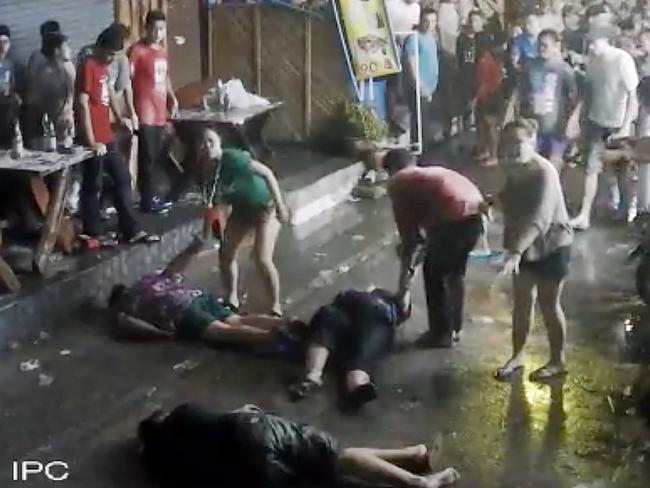 Bystanders help the family after the attack. Son Lewis, foreground, mother Rosemary, 65, centre and father Lewis Sr, 68, back left. Picture: Hua Hin Municipality.