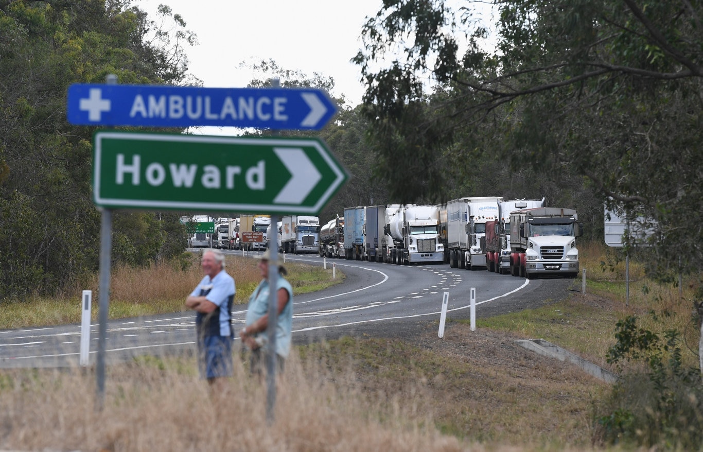 Two vehicle crash at the intersection of Thomas St, Howard and the Bruce Highway. A long line of trucks banked up north of the crash site.