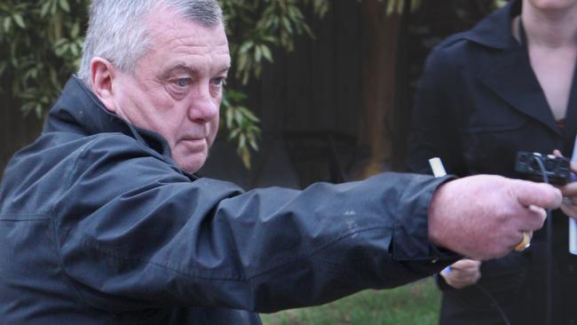 Des Moran shows how a shooter fired from the front of his car in Ascot Vale in a failed hit.