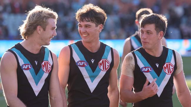 ADELAIDE, AUSTRALIA - JULY 06: Jason Horne-Francis, Connor Rozee and Zak Butters of the Power celebrate their win during the 2024 AFL Round 17 match between the Port Adelaide Power and the Western Bulldogs at Adelaide Oval on July 05, 2024 in Adelaide, Australia. (Photo by James Elsby/AFL Photos via Getty Images)