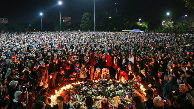 Mourners pay their respects for Eurydice Dixon at Princess Park, where she died last week. (Pic: Michael Dodge)