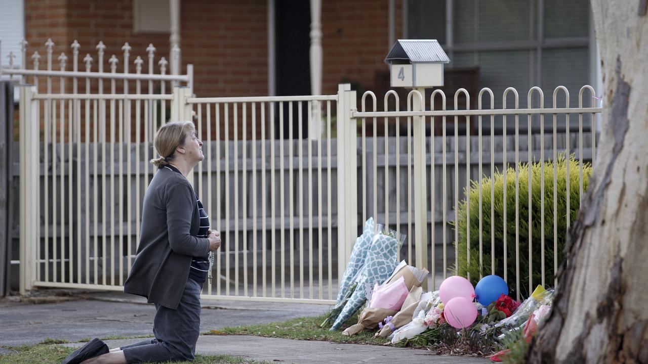 Mary D’Amico prays on Friday at the front of the home in Burgess Street. Picture: David Geraghty