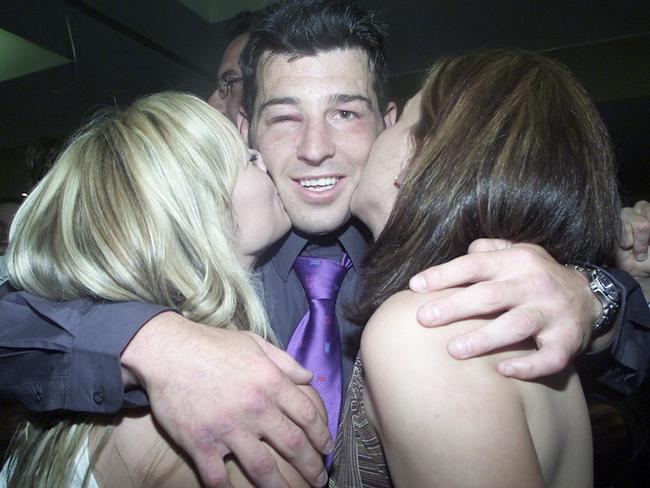 OCTOBER 5, 2003 : Penrith Panthers captain Craig Gower embraced by fans at local leagues club following 05/10/03 victory over Sydney Roosters in NRL grand final. Pic Troy Bendeich.Rugby League / Fan