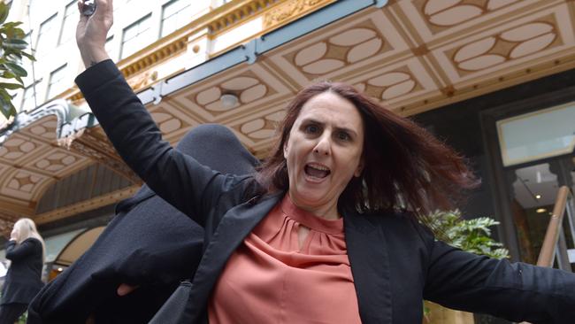 DeFrenza underneath his suit jacket with a female supporter outside court.