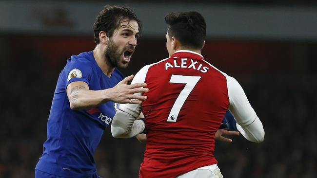 Chelsea's Spanish midfielder Cesc Fabregas (L) reacts to a tackle by Arsenal's Chilean striker Alexis Sanchez