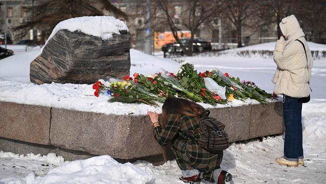 People lay flowers for Alexei Navalny at the Solovetsky Stone, a monument to political repression in Moscow. Picture: AFP