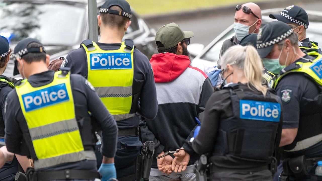 A man is arrested in Treasury Gardens in Melbourne at Friday fizzer of a protest. Picture: Tony Gough