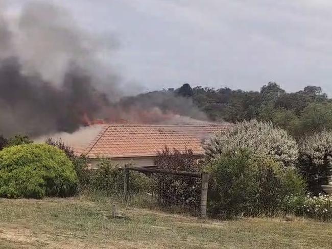 The view from the street as a fire engulfed the Hidden Valley home. Picture: Supplied