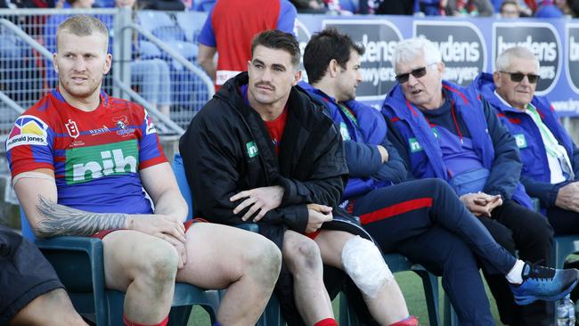 Connor Watson (jacket) on the bench with a knee injury.