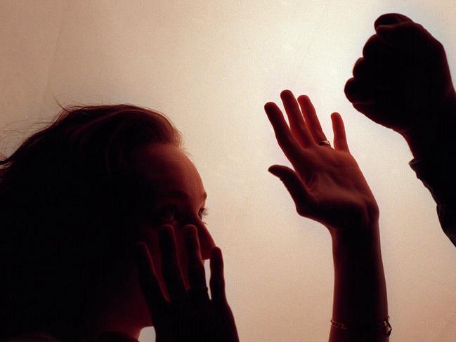 Domestic violence silhouette generic image - fist raised against woman./Violence