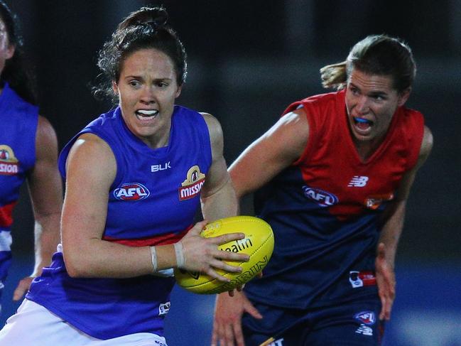 MELBOURNE, AUSTRALIA - SEPTEMBER 03: Emma Kearney of the Bulldogs runs with the ball from Chelsea Randall of the Demons during the AFL Women's Exhibition Match between the Western Bulldogs and the Melbourne Demons at Whitten Oval on September 3, 2016 in Melbourne, Australia. (Photo by Michael Dodge/Getty Images)