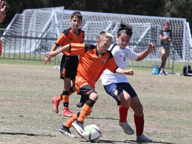 The Premier Invitational football tournament on the Gold Coast. Brisbane Roar Orange v TFC Brisbane White under-13s in action. Picture: Mike Batterham.