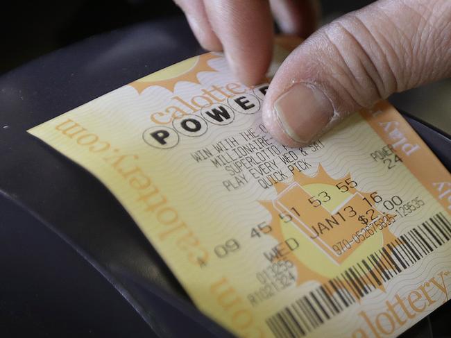 A store clerk removes a Powerball quick pick lottery ticket Wednesday, Jan. 13, 2016, in Oakland, Calif. The Powerball jackpot has grown to over $1 billion dollars. (AP Photo/Ben Margot)