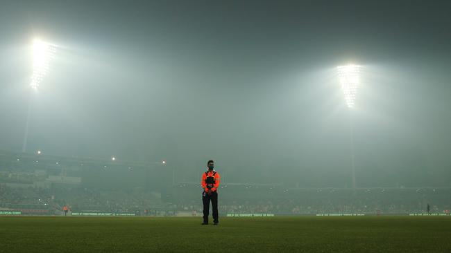 A security guard stands amongst smoke haze during the Big Bash League match at Manuka Oval in Canberra. Picture: Getty Images