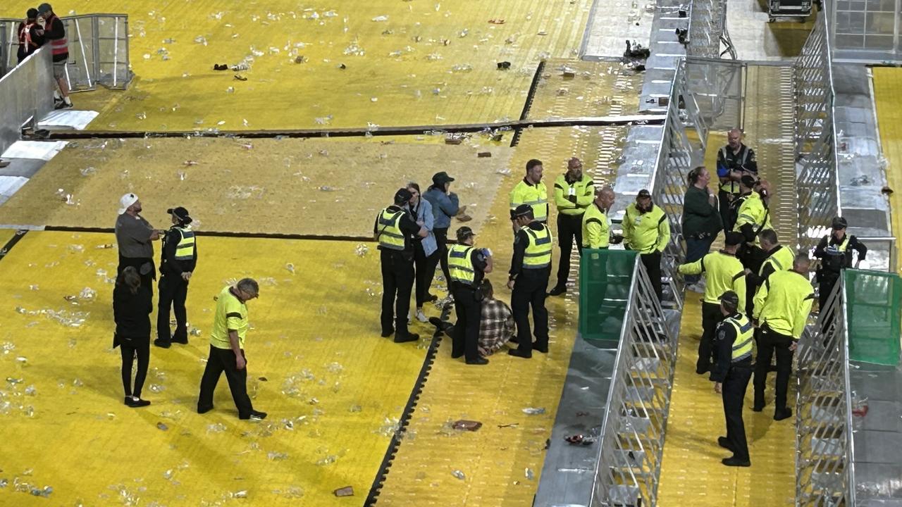 Security guards restrain two men after the Foo Fighters concert at Coopers Stadium on Saturday. Picture: Gemma Jones