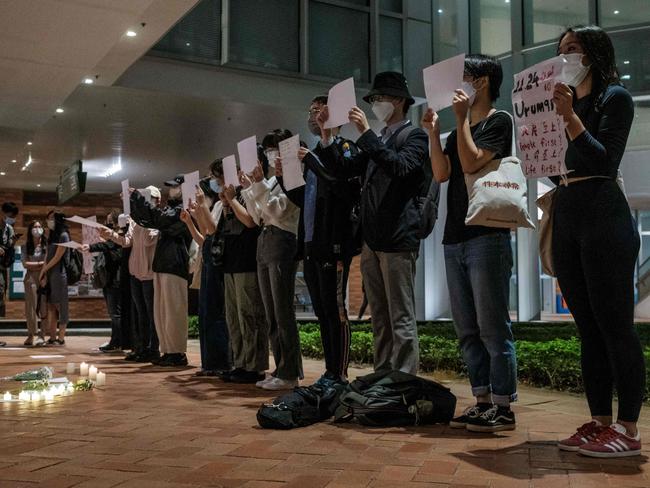 Protesters hold up signs at the University of Hong Kong campus. Picture: Yan Zhao/AFP