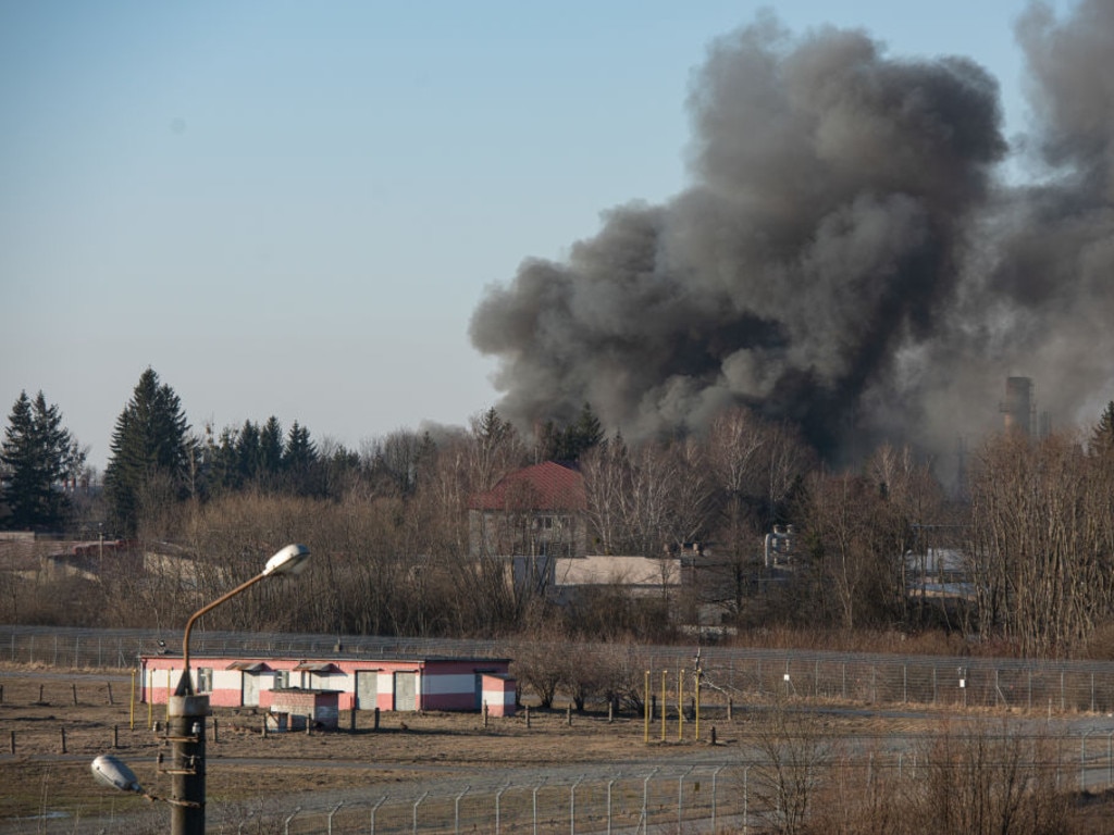 Smoke is seen above buildings close to the airport on March 18, 2022 in Lviv.