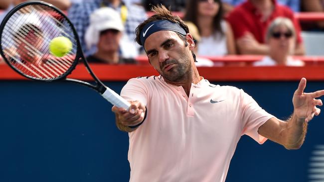 Roger Federer hits a return against Roberto Bautista Agut in their quarter-final.