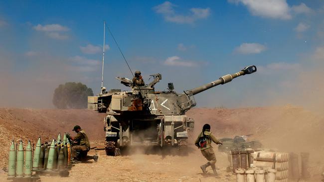 Israeli soldiers fire a 155mm self-propelled howitzer towards the Gaza Strip from their position near the southern Israeli city of Sderot on May 13. Picture: AFP