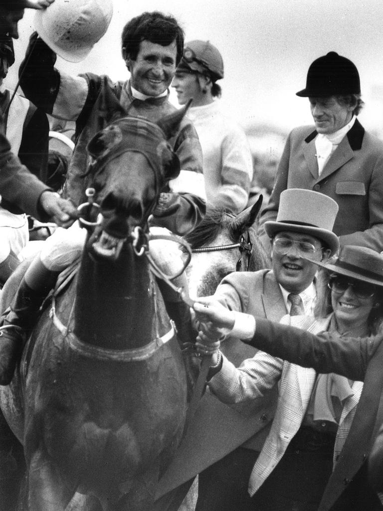 Jockey Pat Hyland and his mount What A Nuisance, with the horse’s co-owners Lloyd and Sue Williams, celebrating their 1985 Melbourne Cup win. Picture: Colin Stuckey.