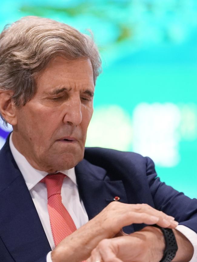 John Kerry, Special Presidential Envoy for Climate, checks his watch.