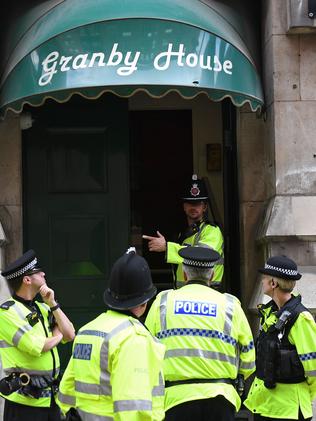 Police swarm an apartment block in central Manchester. Picture: AFP/Chris J Ratcliffe