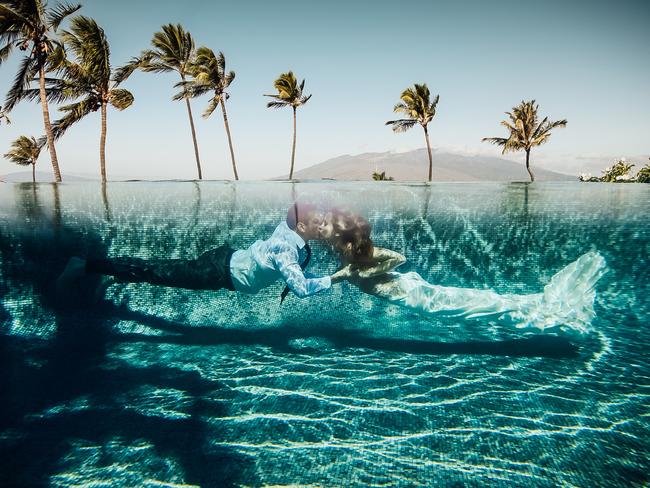 Dina Chmut took this amazing photo of a couple kissing underwater while in their wedding attire in a pool in Maui, Hawaii.