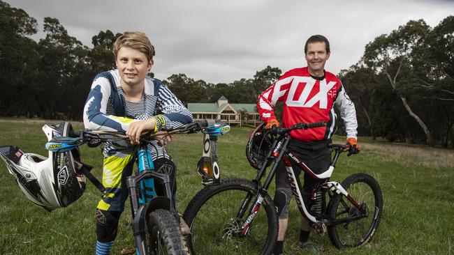 Joff Medder from Inside Line downhill bike club, with Izack Fielder, 13, at the former golf course at Belair. Picture: Simon Cross