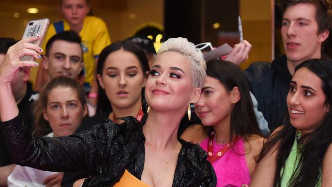 Katy Perry gathers some of her supporters, including Pypah Webber, Myrah Bijelic and Kiona Maro, for a quick snap. Picture: Josie Hayden