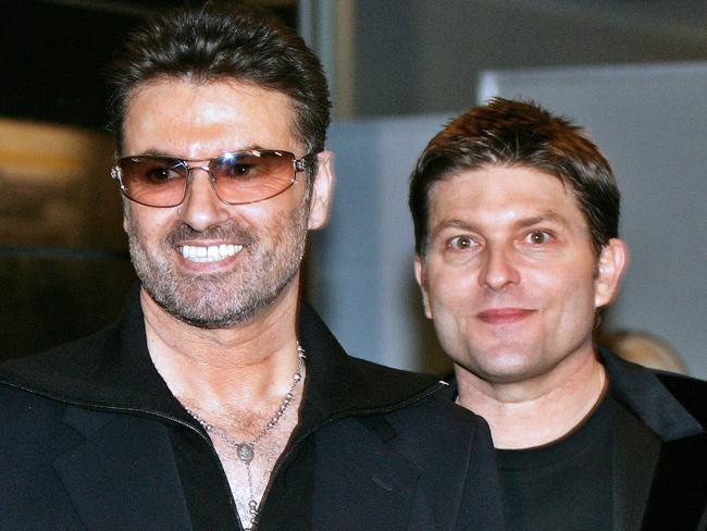 George Michael smiles with his former partner Kenny Goss. Picture: AFP