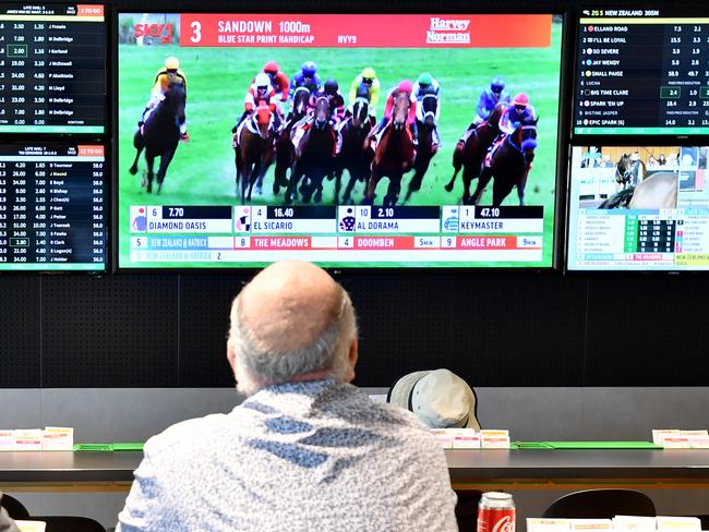 Customer's are seen inside a Tabcorp venue in Brisbane, Wednesday, August 14, 2019. Tabcorp Holdings, which operates in the gambling and media industry announced a net profit after tax (NPAT) result for the full year of $362.5 million and revenue of $5.5 billion from its Lottery, Keno, TAB, and Sky Racing business. (AAP Image/Darren England) NO ARCHIVING