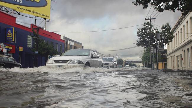 Cars forge through a flooded South Melbourne street in 2005 after record rainfall