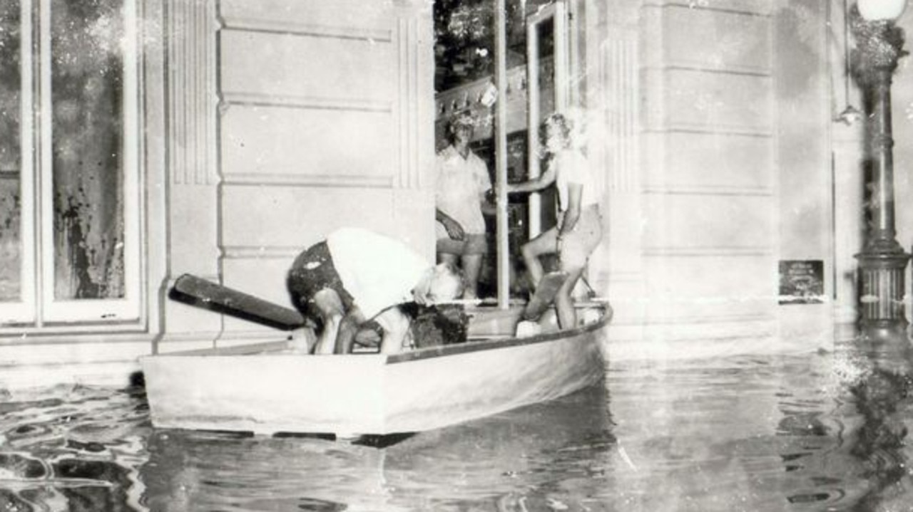 Saving precious Items from the School of Arts, Maryborough, 1955 Flood. Residents rescue valuable belongings from the School of Arts amid rising waters. Source: Unknown