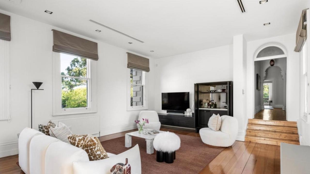 The home’s formal living spaces feature soaring ceilings, stained-glass windows and ornate cornicing, with heritage charm flowing through the sitting room, dining area, and library.