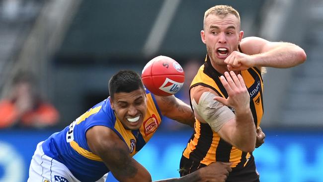 Tom Mitchell of the Hawks handballs while being tackled by Tim Kelly of the Eagles during the round eight AFL match between the Hawthorn Hawks and the West Coast Eagles. (Photo by Quinn Rooney/Getty Images)