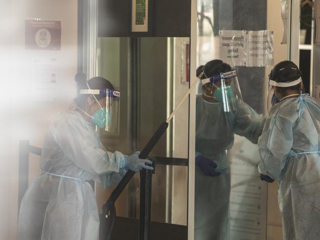 Cleaners wearing full PPE disinfect the Holiday Inn Hotel.