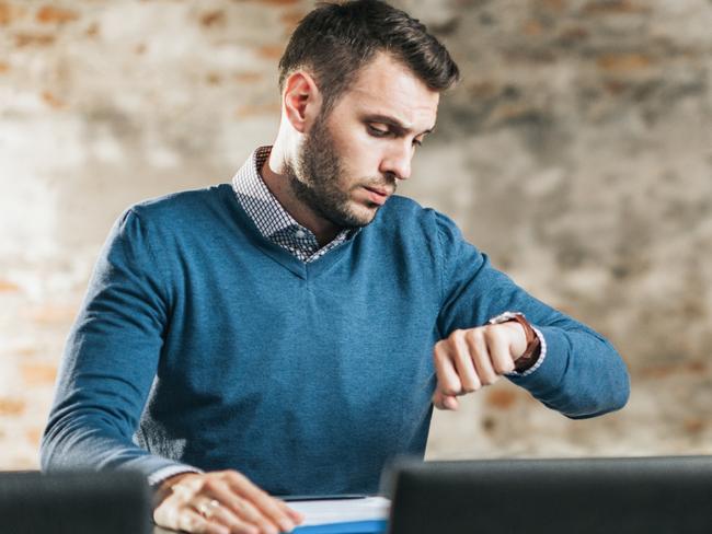 CAREERS: Young businessman checking the time while waiting for HR team on a job interview. Copy space.