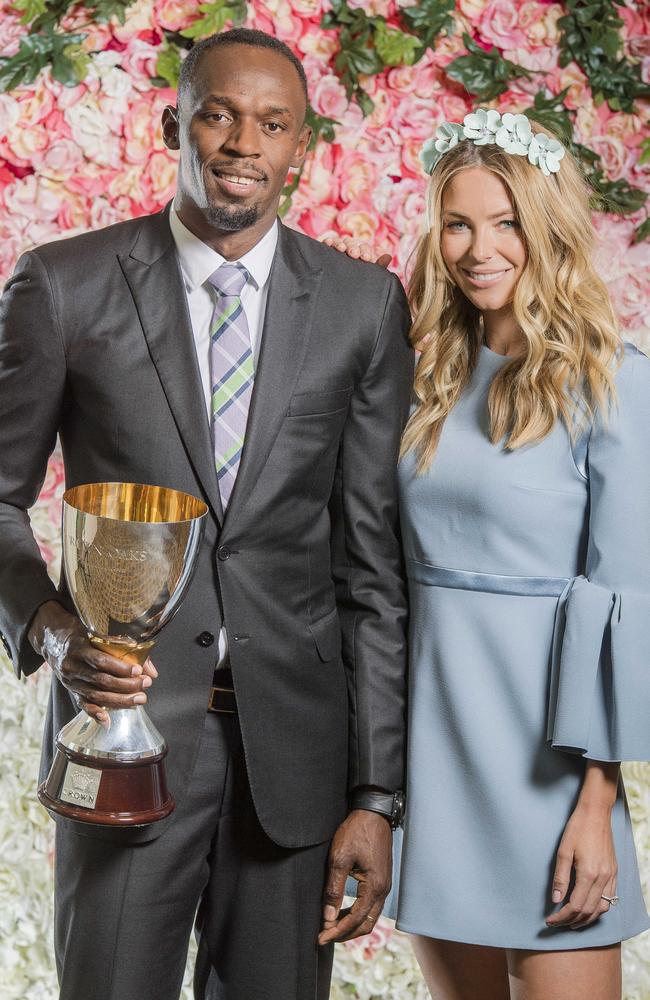 Usain Bolt and Jennifer Hawkins with the Crown Oaks 2016 Cup. Picture: Jason Edwards