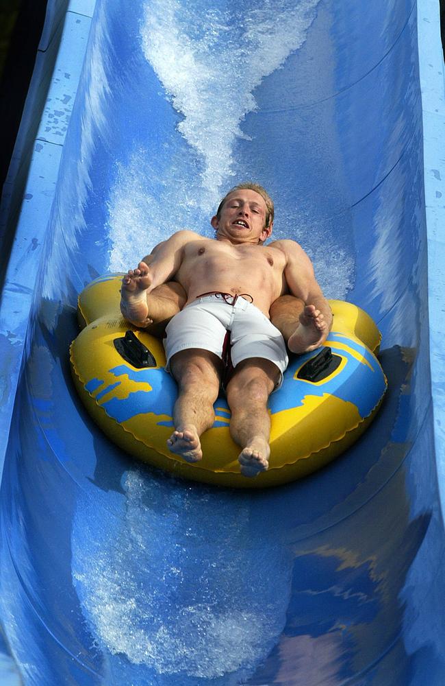 Matt Dawson, scrum-half with England's Rugby World Cup side comes down the "White Water Mountain" ride at "Wet n Wild" on the Gold Coast in Queensland, 28 October 2003. Picture: AFP / Greg Wood