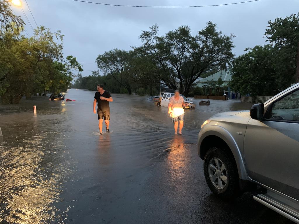 Residents are fleeing from their homes to higher ground as water fills the streets. Picture: Stuart Cumming