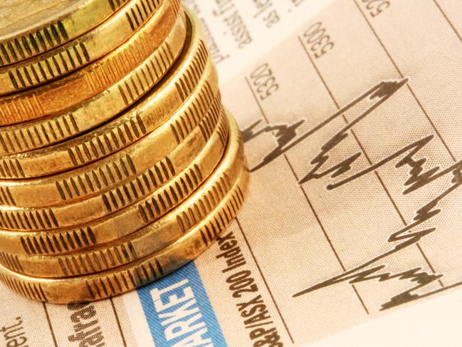 A stack of gold coins on a finance page stock market index graph. ASX investing Australian money generic