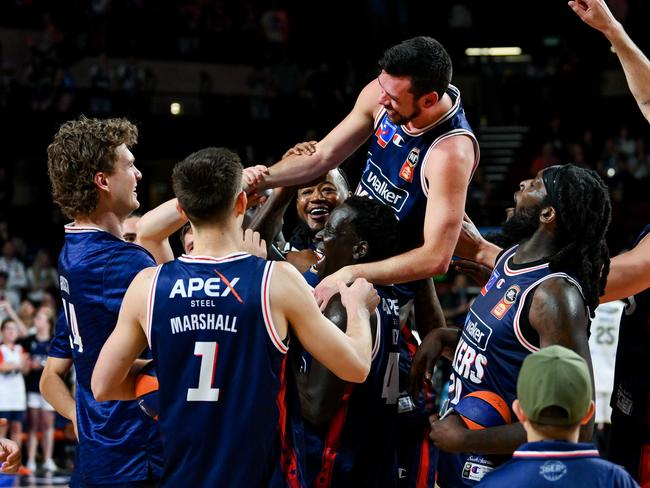 ADELAIDE, AUSTRALIA - OCTOBER 20: 36ers lift Jason Cadee of the 36ers  up after winning his 400th game during the round five NBL match between Adelaide 36ers and Tasmania Jackjumpers at Adelaide Entertainment Centre, on October 20, 2024, in Adelaide, Australia. (Photo by Mark Brake/Getty Images)